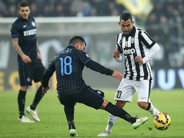 Inter Milan's Chilean midfielder Gary Medel fights for the ball with Juventus' Argentinian forward Carlos Tevez during the Italian Serie A football match on January 6, 2015