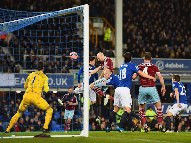 James Collins of West Ham United (C) scores their first goal with a header past goalkeeper Joel Robles of Everton during the FA Cup Third Round match on January 6, 2015