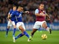Danny Simpson of Leicester City passes the ball as Gabriel Agbonlahor of Aston Villa closes in during the Barclays Premier League match between Leicester City and Aston Villa at The King Power Stadium on January 10, 2015