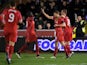 Steven Gerrard of Liverpool is congratulated by teammates Mamadou Sakho and Jordan Henderson after scoring his team's second goal from a free kick during the FA Cup Third Round match between AFC Wimbledon and Liverpool at The Cherry Red Records Stadium on