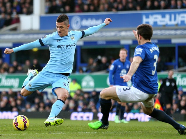 Stevan Jovetic of Manchester City takes a shot on goal as Leighton Baines of Everton atempts to block during the Barclays Premier League match between Everton and Manchester City at Goodison Park on January 10, 2015