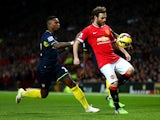 Juan Mata of Manchester United battles for the ball with Eljero Elia of Southampton during the Barclays Premier League match between Manchester United and Southampton at Old Trafford on January 11, 2015