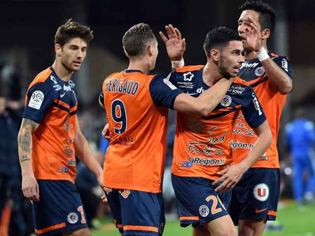 Montpellier's players celebrate after scoring a goal during the French L1 football match between Montpellier and Marseille at the La Mosson Stadium in Montpellier, southern France, on January 9, 2015