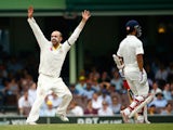 Nathan Lyon of Australia celebrates after taking the wicket of Wriddhiman Saha of India during day five of the Fourth Test match between Australia and India at Sydney Cricket Ground on January 10, 2015