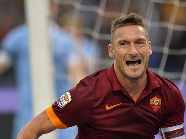 Roma' Francesco Totti celebrates after scoring during a Serie A soccer  match between Juventus and Roma at the Juventus stadium, in Turin, Italy,  Sunday, Oct. 5, 2014. (AP Photo/Massimo Pinca Stock Photo -