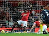 Manchester United's English defender Tyler Blackett can't reach the shot from Southampton's Serbian midfielder Dusan Tadic as Tadic scores the opening goal during the English Premier League football match between Manchester United and Southampton at Old T