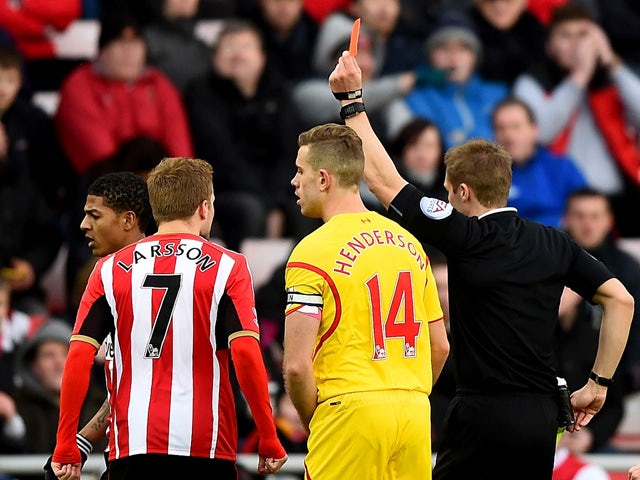 Referee Craig Pawson shows a red card to Liam Bridcutt of Sunderland during the Barclays Premier League match between Sunderland and Liverpool at Stadium of Light on January 10, 2015