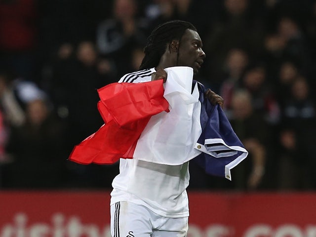 Bafetibi Gomis of Swansea celebrates his team's second goal with the French flag during the Barclays Premier League match between Swansea City and West Ham United at Liberty Stadium on January 10, 2015