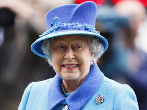 The Queen smiles as she watches horses on October 18, 2014