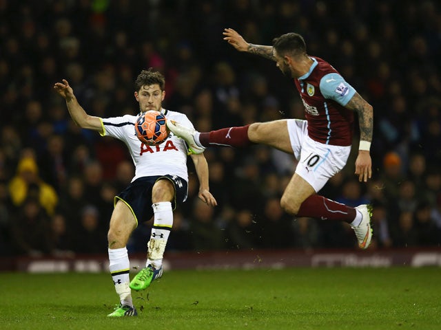 Ben Davies of Tottenham Hotspur is challenged by Danny Ings of Burnley during the FA Cup Third Round match between Burnley and Tottenham Hotspur at Turf Moor on January 5, 2015