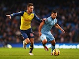 Aaron Ramsey takes on Sergio Aguero during Arsenal's 2-0 win over Manchester City on January 18, 2015