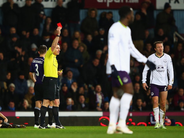 Aidan McGeady of Everton (R) is shown a red card and is sent off by referee Neil Swarbrick after a challenge on Mark Noble of West Ham United on January 13, 2015