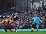 West Ham United's English striker Andy Carroll (2nd L) shoots to score the opening goal past Hull City's Scottish goalkeeper Allan McGregor (R) during the English Premier League football match on January 18, 2015