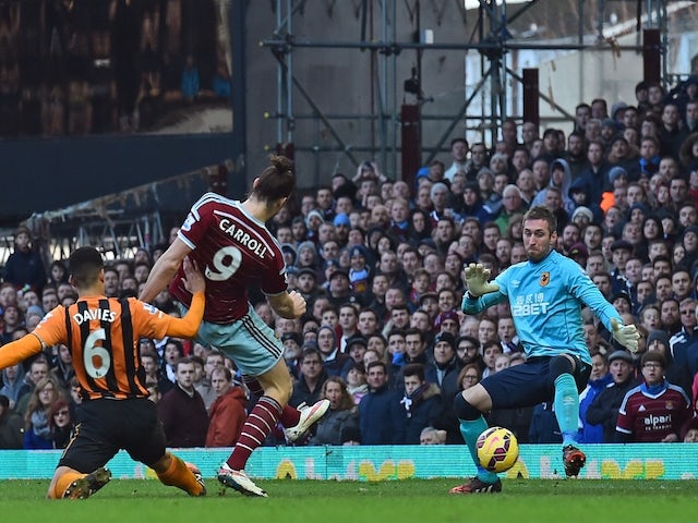 West Ham United's English striker Andy Carroll (2nd L) shoots to score the opening goal past Hull City's Scottish goalkeeper Allan McGregor (R) during the English Premier League football match on January 18, 2015