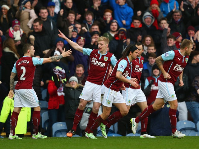 Ben Mee of Burnley celebrates scoring the opening goal with team mates during the Barclays Premier League match between Burnley and Crystal Palace at Turf Moor on January 17, 2015