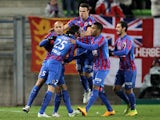 Caen's French midfielder Julien Feret is congratulated by his teamates after scoring a goal during the French L1 football match between Caen (SM Caen) and Reims (RS), on January 17, 2015