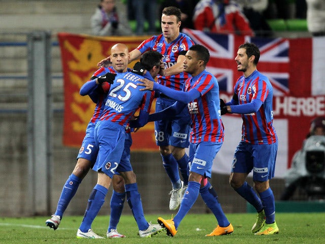 Caen's French midfielder Julien Feret is congratulated by his teamates after scoring a goal during the French L1 football match between Caen (SM Caen) and Reims (RS), on January 17, 2015