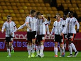 Cauley Woodrow of Fulham celebrates with team-mates after scoring the opening goal during the FA Cup third round replay match against Wolves on January 13, 2015