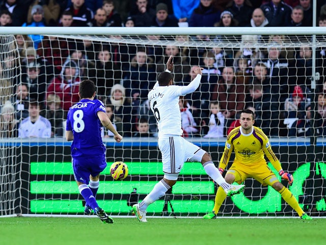 Chelsea player Oscar shoots to score the opening goal during the Barclays Premier League match between Swansea City and Chelsea at Liberty Stadium on January 17, 2015 
