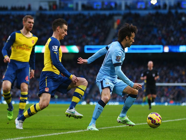 David Silva of Manchester City is watched by Laurent Koscielny of Arsenal during the Barclays Premier League match on January 18, 2015
