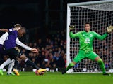 Enner Valencia of West Ham United shoots past goalkeeper Joel Robles of Everton to score their first goal during the FA Cup Third Round Replay on January 13, 2015