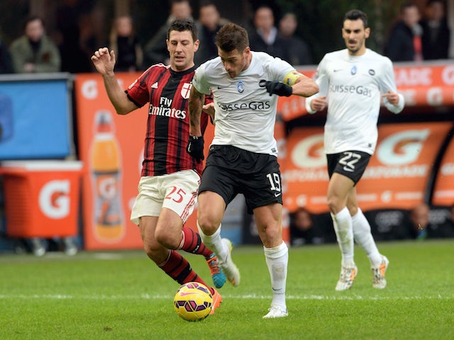 Gustavo Denis of Atalanta BC competes for the ball with (L) Daniele Bonera of AC Milan during the Serie A match on January 18, 2015