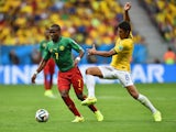 Landry N'Guemo of Cameroon controls the ball against Paulinho of Brazil during the 2014 FIFA World Cup Brazil Group A match between Cameroon and Brazil at Estadio Nacional on June 23, 2014