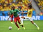 Landry N'Guemo of Cameroon controls the ball against Paulinho of Brazil during the 2014 FIFA World Cup Brazil Group A match between Cameroon and Brazil at Estadio Nacional on June 23, 2014