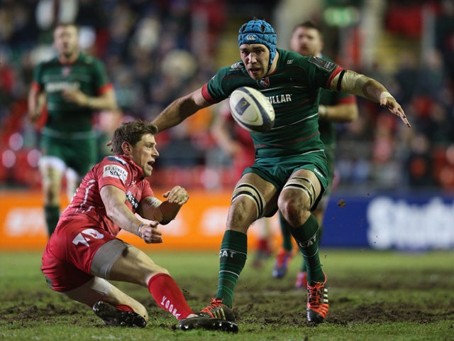 Rhys Priestland of Scarlets passes the ball as Graham Kitchener of Leicester Tigers moves in to tackle during the European Rugby Champions Cup Group 3 match between Leicester Tigers and Scarlets at Welford Road on January 16, 2015