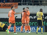 Lorient's French Portuguese defender Raphael Guerreiro celebrates with his teammate Belgian forward Gianni Bruno and other teammates after scoring a goal during the French L1 football match Lorient (FCL) vs Lille (LOSC) on January 17, 2015