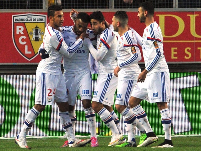 Lyon's French forward Alexandre Lacazette is congratulated by teammates after scoring during the French L1 football match Lens vs Olympique Lyonnais on January 17, 2015