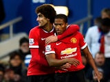 Marouane Fellaini of Manchester United celebrates with team-mate Luis Antonio Valencia after scoring the opening goal during the Barclays Premier League match between Queens Park Rangers and Manchester United at Loftus Road on January 17, 2015 