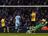 Arsenal's Spanish midfielder Santi Cazorla (L) scores the opening goal from the penalty spot past a diving Manchester City's English goalkeeper Joe Hart (2R) during the English Premier League match on January 18, 2015