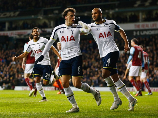 Vlad Chiriches of Spurs (6) celebrates with team mate Younes Kaboul as he scores their third goal during the FA Cup Third Round Replay match between Tottenham Hotspur and Burnley at White Hart Lane on January 14, 2015