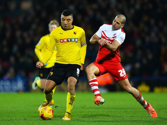 Troy Deeney of Watford holds off Tal Ben-Haim of Charlton during the Sky Bet Championship match between Watford and Charlton Athletic at Vicarage Road on January 17, 2015