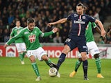 Paris Saint-Germain's Swedish midfielder Zlatan Ibrahimovic (R) vies with Saintt-Etienne's French defender Loïc Perrin during the French Ligue Cup football match on January 13, 2015