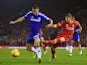 Alberto Moreno of Liverpool is challenged by Gary Cahill of Chelsea during the Capital One Cup Semi-Final first leg match on January 20, 2015