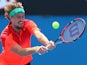 Alexander Kudryavtsev of Russia plays a backhand in his first round match against Marinko Matosevic of Australia during day one of the 2015 Australian Open on January 19, 2015