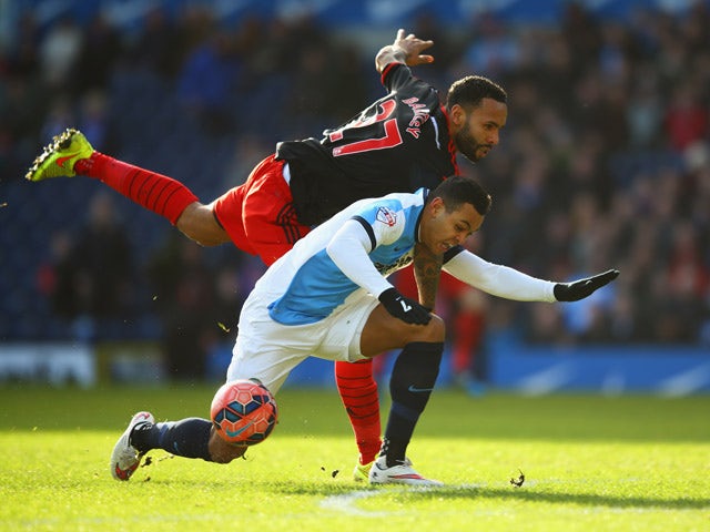 Kyle Bartley of Swansea City tangles with Joshua King of Blackburn Rovers during the FA Cup Fourth Round match between Blackburn Rovers and Swansea City at Ewood park on January 24, 2015