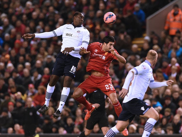 Bolton Wanderers' English striker Emile Heskey climbs to win a header from Liverpool's German midfielder Emre Can during the FA Cup fourth round football match between Liverpool and Bolton Wanderers at Anfield in Liverpool, northwest England, on January 2