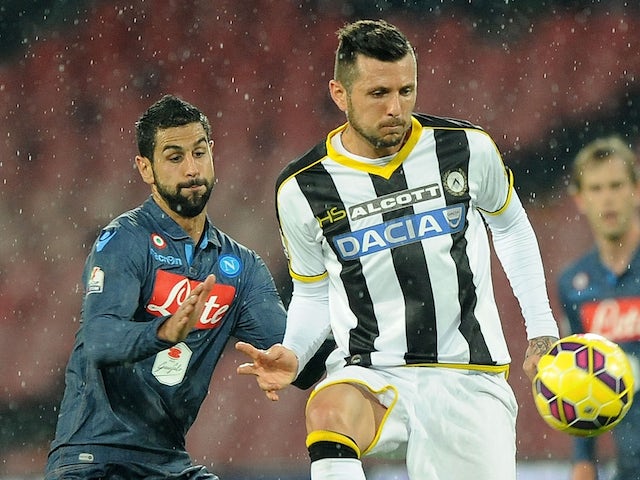 Udinese's player Cyril Thereau vies with Napoli player Miguel Britos during the TIM CUP match on January 22, 2015