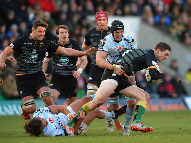 George North of Northampton Saints escapes a tackle by Antonie Claassen of Racing Metro 92 during the European Rugby Champions Cup match on January 24, 2015