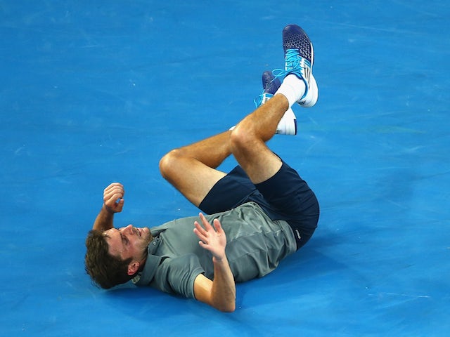 Gilles Simon of France has a fall in his third round match against David Ferrer of Spain during day six of the 2015 Australian Open at Melbourne Park on January 24, 2015
