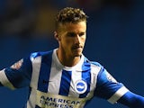 Joe Bennett of Brighton is challenged by Roger Espinoza of Wigan during the Sky Bet Championship match against Wigan Athletic on November 4, 2014