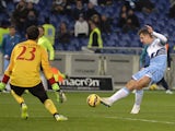 Lazio's forward from Germany Miroslav Klose shoots and scores against AC Milan's goalkeeper from Spain Diego Lopez during the Italian Serie A football match on 24 January, 201