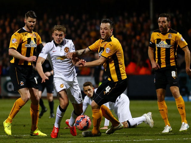James Wilson of Manchester United battles for the ball with Josh Coulson of Cambridge United during the FA Cup Fourth Round match between Cambridge United and Manchester United at The R Costings Abbey Stadium on January 23, 2015