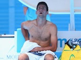 Novak Djokovic takes a breather during his first-round match at the Australian Open on January 20, 2014