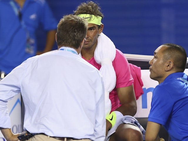 Rafael Nadal talks to his trainer on day three of the Australian Open on January 21, 2015