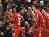 Liverpool's English midfielder Raheem Sterling (L) celebrates scoring an equalising goal during the English League Cup semi-final first leg football match against Chelsea on January 20, 2015