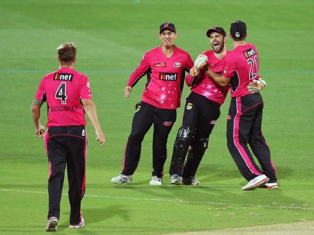 Sixers players celebrate with teammate Ryan Carters after he took a catch to dismiss Johan Botha of the Adelaide Strikers during the Big Bash League Semi FInal match between the Adelaide Strikers and the Sydney Sixers at Adelaide Oval on January 24, 2015